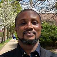 Headshot of a black man with short black hair