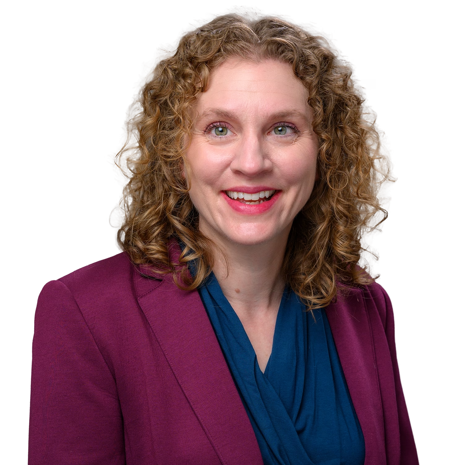 Woman with light brown curly hair wearing a maroon-colored blazer and navy shirt