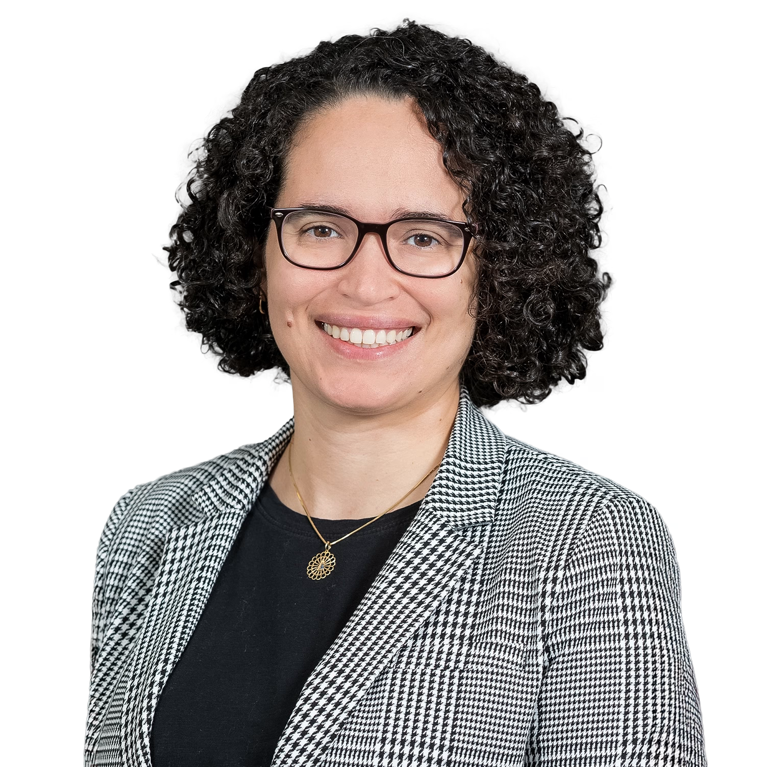 headshot of a woman with light skin, medium-length black burly hair, and glasses